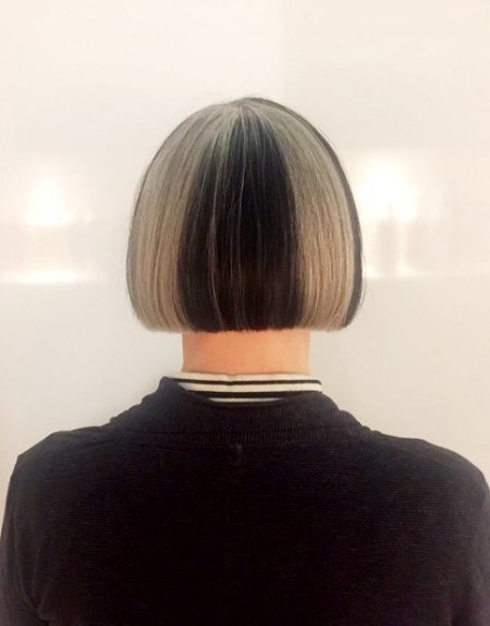Natural grey hair has been coloured black on certain areas on hair to create a block effect at the klinik hairdressing London.