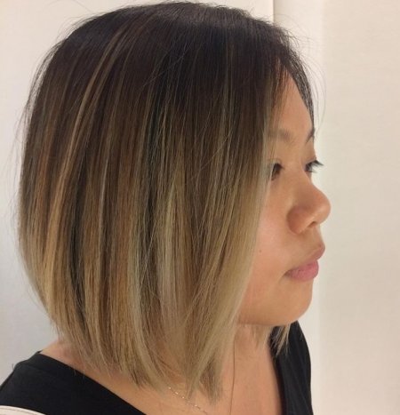 Dark brown hair being coloured with a sombre ombre technique to create a dark to blonde effect throughout the hair with no unwanted tones using Olaplex at the klinik salon London