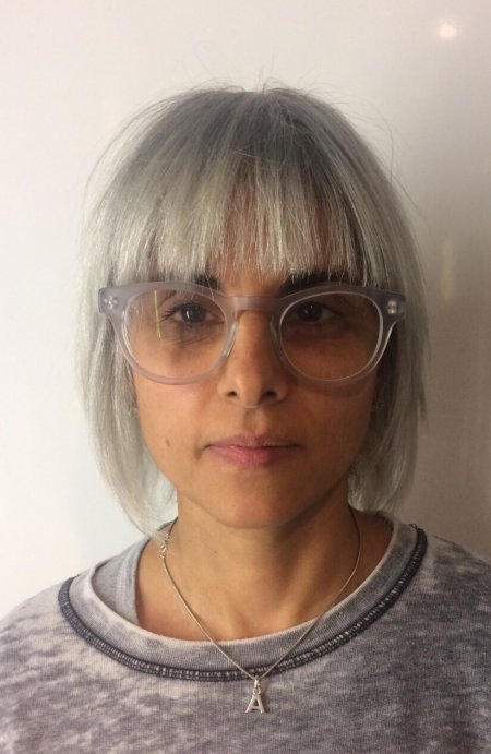 hair colour being faded from blond to dark grey to light grey at the klinik salon Farringdon