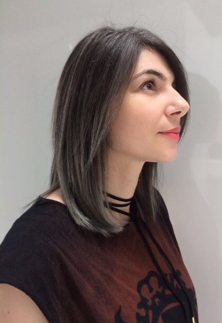 Hair being coloured using a balayage technique going from a dark base to silver using Olaplex and Igora Royal colours done by Thea at the klinik hairdressing London Exmouth market EC1R 4QE