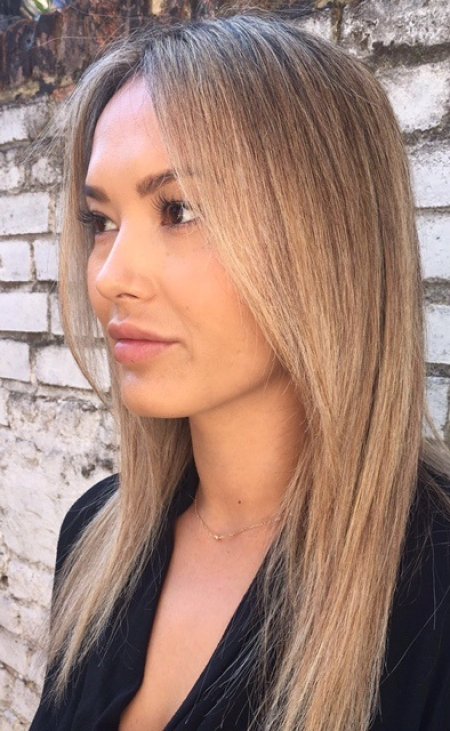 Long straight hair has been coloured using babylights to create a soft blonde that looks sunkissed and natural. Hair done by thea at the klinik hairdressing Farringdon