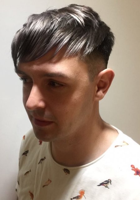 Gents hair coloured into a charcoal grey with white tips to create texture throughout the layers. Done by Mark at the klinik hairdressing London.