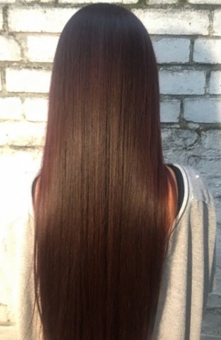Natural long hair has been enhanced by applying a beautiful rich diarichesse brown plum by L'Oreal.