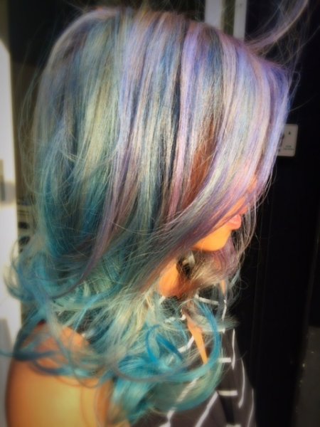 Mermaid hair being coloured in multi colour from pink, blue, silver by Thea at the klinik hairdressing London