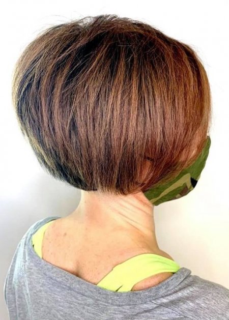 Girl with a brown bob and grey top
