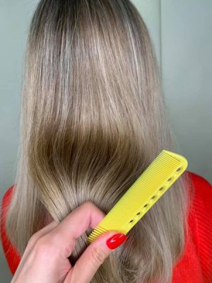 Highlighted hair with a yellow comb at the klinik salon London
